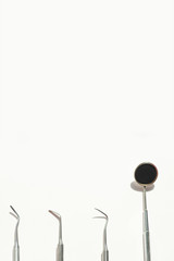 a various dental tools laid out flatlay on a light background