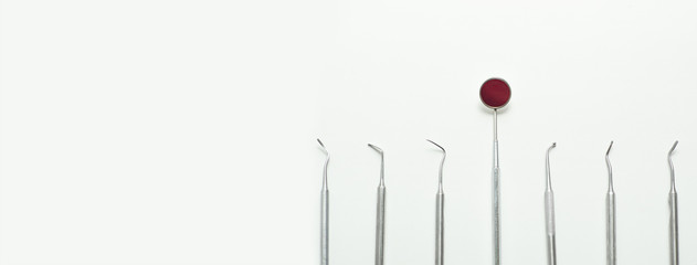 a various dental tools laid out flatlay on a light background