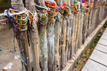 Colourful bracelets left by visitors at the site of a mass grave, Choeung Ek Killing Fields...