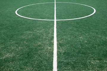 Fototapeta na wymiar Fragment of footbal field with artificial grass.