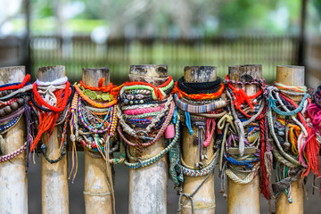 Colourful bracelets left by visitors at the site of a mass grave, Choeung Ek Killing Fields...