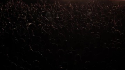 Big crowd of people dancing on music festival concert at night, street music big event