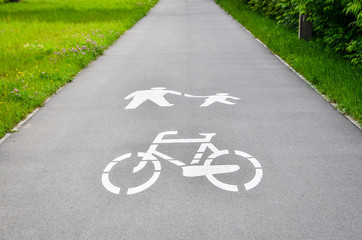 Fototapeta premium Bicycle path with sign in the park