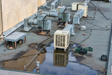 Air conditioning systems on roof of commercial buildings. The rooftop location benefits from less...