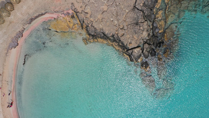 Aerial top view photo of men practising wind surfing in exotic paradise open ocean bay with crystal clear turquoise sea