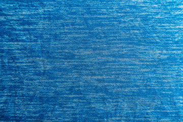 A uniformly lit blue fabric texture with soft shadows.