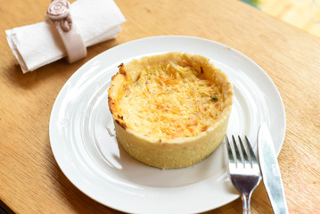 chicken quiche with rolled napkin and tableware