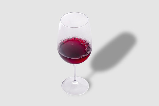 Glass of red wine on gray background