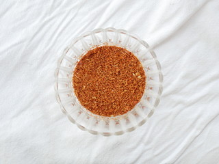 Cayenne pepper in glass bowl isolated white background