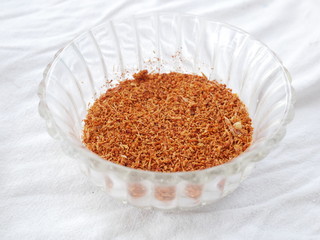 Cayenne pepper in glass bowl isolated white background