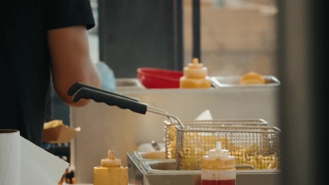 French fries cooking on deep fryer on festival. French fries cooking on deep fryer