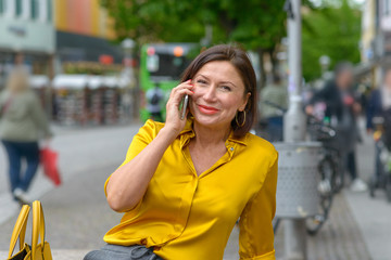 Happy woman chatting on her mobile phone