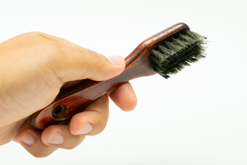 shoe polish brush in hand on white background