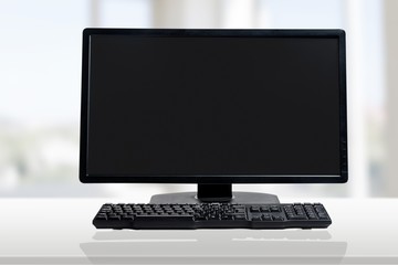 Desktop computer and keyboard on background