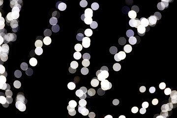 Abstract bokeh of white lights on black background. defocused and blurred many round light