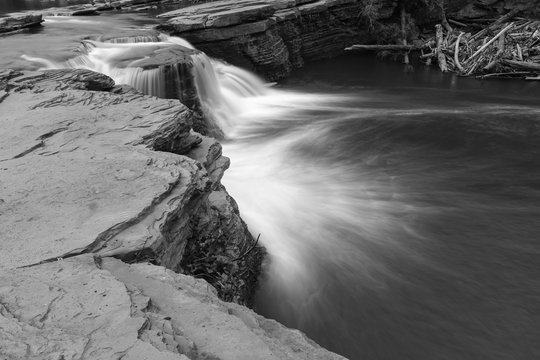 Close up black and white image of a powerful waterfall in Tumbler Ridge, British Columbia, Canada, long exposure to create blurred motion to the water, nobody in the image