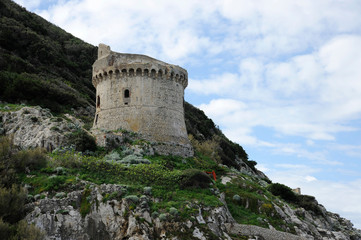 Fototapeta na wymiar Ancient defense tower Torre Paola on a hill near the Mediterranean Sea in the Circeo National Park. Coast of Lungomare di Sabaudia, province of Latina, Lazio region in central Italy.