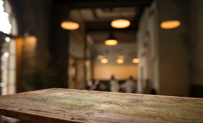 blurred background of bar and dark brown desk space of retro wood