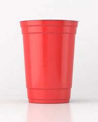 Red 16oz 455ml american plastic party cup on a white table against a white wall. 3d render. Front view. Conceptual Scenes Series.