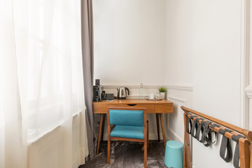 Corner of a hotel apartment with working table and chair