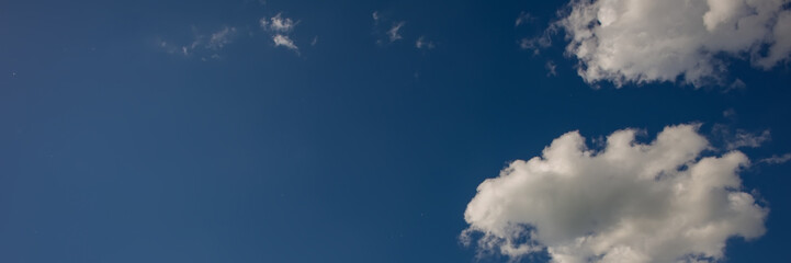 White clouds on a blue background on a sunny day.