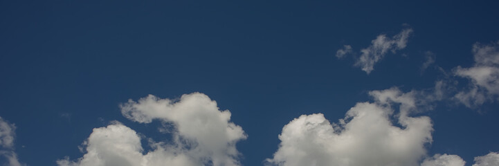 White clouds on a blue background on a sunny day.
