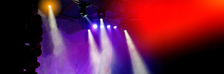 Blurred background, stage lighting during a rock concert.