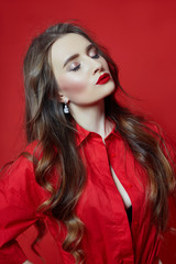 Romantic woman with long blonde hair in red dress, smooth clean skin