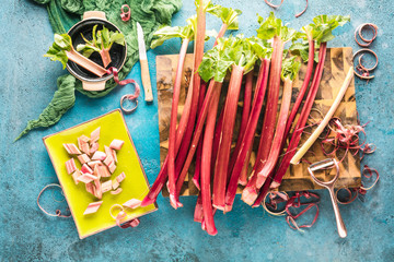 Fototapeta premium Draufsicht von frischen reifen gesunden Rhabarberstielen auf hölzernem Brett