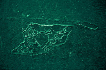 Vintage green background. Rough painted wall of emerald color. Imperfect plane of virid colored. Uneven old decorative toned backdrop of green tint. Texture of emerald hue. Ornamental stony surface.