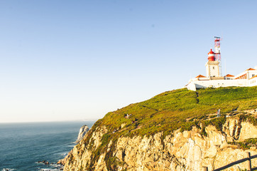 Fototapeta na wymiar beautiful lighthouse near ocean and rocks