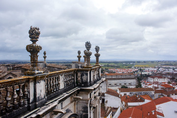 Fototapeta premium View of the city from the rooftop of Cathedral of Evora on a cloudy day. With copy space.