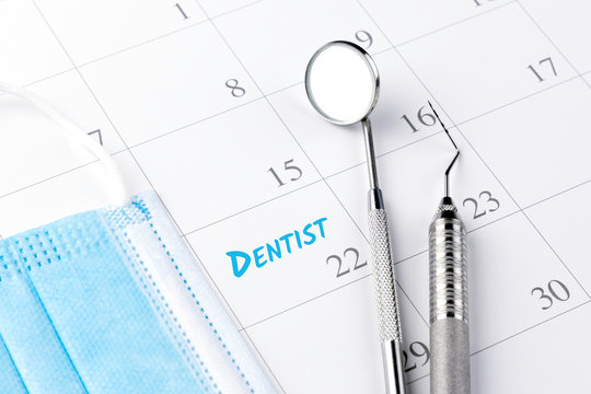 Reminder dentist appointment in calendar and professional dental tools.- Image
