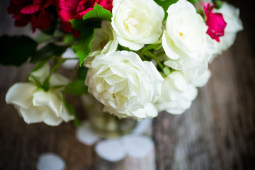 bouquet of beautiful red and white roses on a wooden