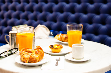 morning breakfast croissant, coffee and fresh orange juice on table