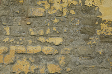 Background of yellow and gray grungy brick wall