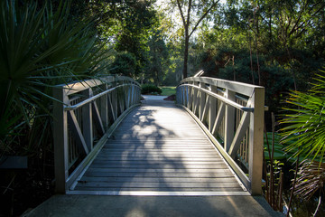 Wooden bridge running through a garden