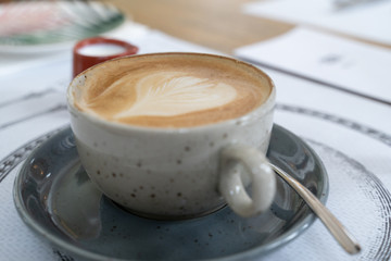 Coffee served at restaurant, cappuccino with a heart shaped froth