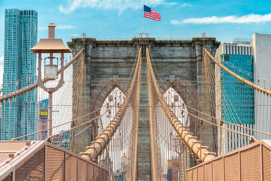Fototapeta Brooklyn Bridge and Manhattan Skyline. Architectural Details, Iconic Steel Cables, American Flag. New York City