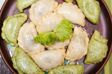Tasty vegetarian dumplings with spinach and salad