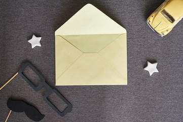 Happy Father's Day. Template for greeting card black paper mustache, glasses and yellow toy car on a blue background with place for text