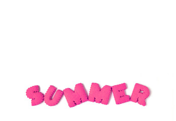 Top view of alphabet shaped biscuits spelling the word SUMMER in vibrant pink color on white background