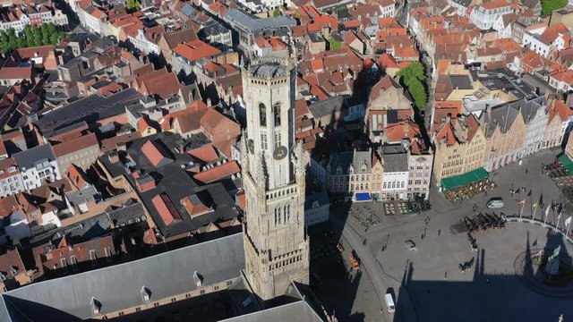 Aerial view of cityscape of Bruges, medieval bell tower Belfry of Bruges (Belfort van Brugge) & famous Market Square Markt in historic center of city - landscape panorama of Belgium from above, Europe