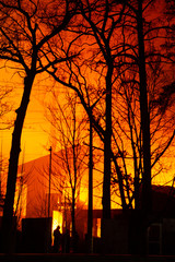 Fire in factory building at night. Firefighters try to put out the fire