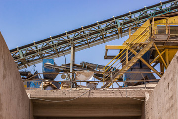 Fototapeta na wymiar disabled and abandoned rust dirt iron industrial factory with production lines machines in dry desert place, causes of environmental pollution and global warming concept photography