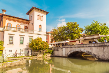 Fototapeta na wymiar Cityscape of Portogruaro in Veneto Italy with lemene river, tower and panorama bridge