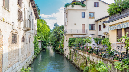 Fototapeta na wymiar Cityscape of Portogruaro in Veneto Italy with lemene river and houses