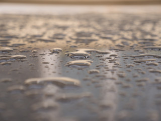 Close up of water droplets on grey car.
