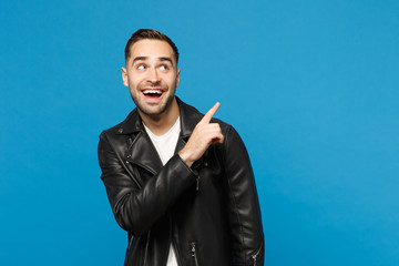 Handsome stylish young unshaven man in black jacket white t-shirt showing on workspace isolated on...