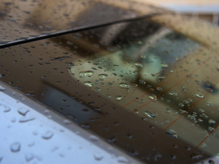 Close up of water droplets on grey car.